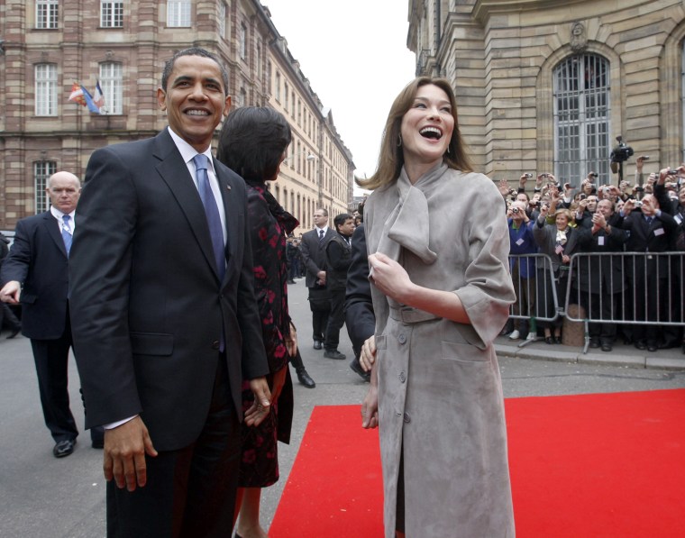 Image: US President Obama laughs with Carla Bruni-Sarkozy on arrival at Palais Rohan in Strasbourg